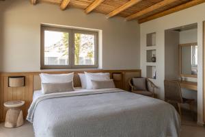 a bedroom with a large bed and a window at Pefkian Ethos Hotel & Suites in Pefki +72 photos