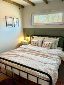 a bedroom with a large bed with a window at POLANKA - Krzynki 16A in Krzynki