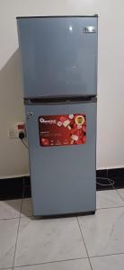 a refrigerator with a sticker on the front of it at Chateau Haven in Kakamega
