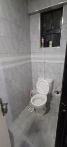a bathroom with a white toilet in a room at Chateau Haven in Kakamega +8 photos