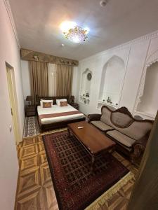 a living room with a bed and a couch at Orom Hotel & Terrace in Bukhara