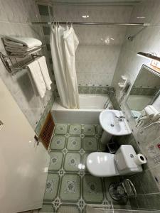 a bathroom with a sink and a toilet and a tub at Orom Hotel & Terrace in Bukhara +47 photos