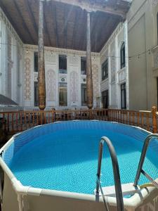 a large swimming pool in a large building with at Orom Hotel & Terrace in Bukhara