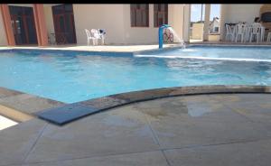 a large swimming pool with a water fountain at Espaço Sonhos da Serra in Bananeiras +3 photos