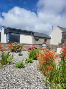 a house with a garden in front of it at Rose Meadow Lodge in Liscannor