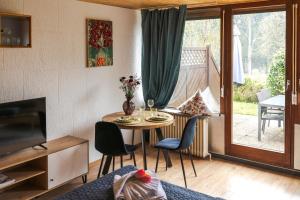 a living room with a table and chairs at Wald Living in Baiersbronn