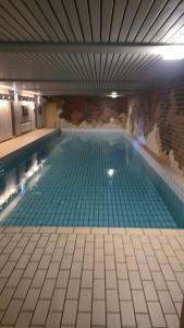 a large swimming pool in a building at Wald Living in Baiersbronn