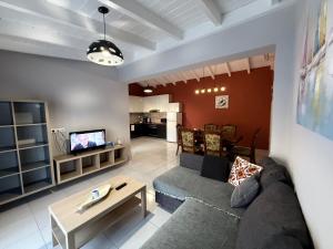 a living room with a couch and a tv at JORGO in Kremasti