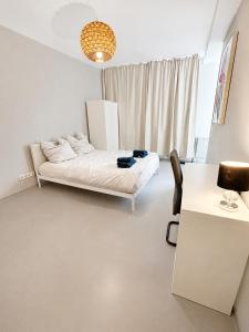 a bedroom with a bed and a desk and a chair at Freedom Studio Apartment in Berlin