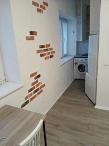 a kitchen with brick walls on the wall at Pärnade Apartment in Paikuse