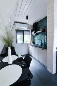 a kitchen and dining room with two tables and chairs at A-frame cottage in Mykulychyn