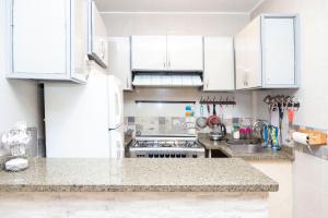 a kitchen with white cabinets and a counter top at Gem View Grand Boutique in Cairo