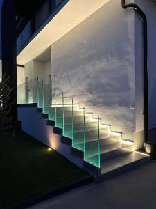 a set of stairs with glass railings on the side of a building at Apartmán Maťko in Levice