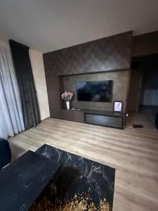 a living room with a flat screen tv on a wall at Apartmán Maťko in Levice