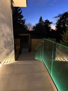 a glass walkway with lights on the side of a building at Apartmán Maťko in Levice