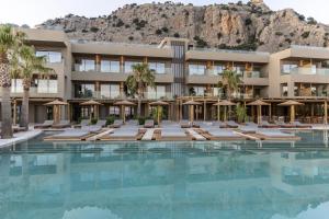 an image of a hotel with a swimming pool at Pefkian Ethos Hotel & Suites in Pefki