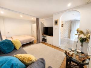a living room with a couch and a bed and a television at Grandma's Corner in Štore