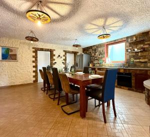 a dining room with a wooden table and chairs at Apartma Olive & Spice in Koper