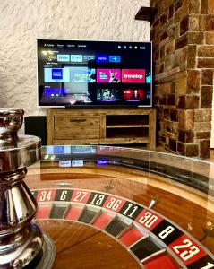a casino table with a television in a room at Apartma Olive & Spice in Koper