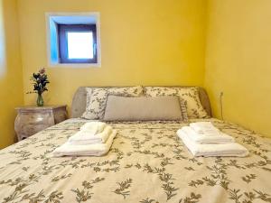 a bedroom with a bed with two towels on it at Apartma Olive & Spice in Koper