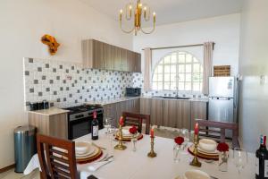 a kitchen with a table with chairs and a refrigerator at White Hill Penthouse in Kisumu