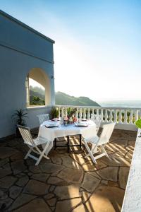 a patio with a table and chairs on a balcony at White Hill Penthouse in Kisumu