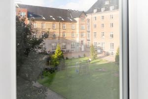 a view of a large building from a window at Central Jylland Suite in Aalborg