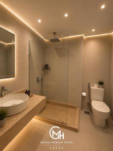 a bathroom with a sink and a toilet and a shower at Grand Museum Hotel Giza in Cairo