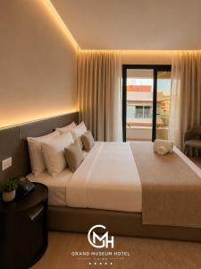 a bedroom with a large bed with a window at Grand Museum Hotel Giza in Cairo +5 photos