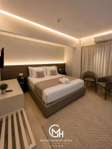 a hotel room with a bed and a living room at Grand Museum Hotel Giza in Cairo