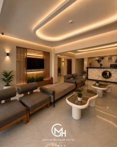 a living room with couches and a tv at Grand Museum Hotel Giza in Cairo