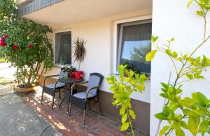 a patio with a table and chairs and a window at Grandma's Corner in Štore