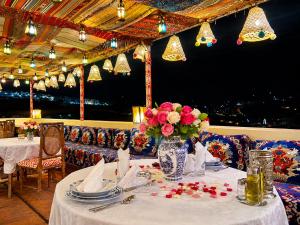 a table with a vase of flowers on top at Riad Fes Palais Bab Sahra Suites & Cooking Workshops in Fez