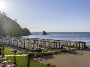a row of tents on a beach next to the ocean at Rixos Premium Tekirova - The Land of Legends Access in Tekirova