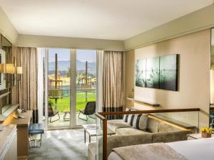 a hotel room with a bed and a living room at Rixos Premium Tekirova - The Land of Legends Access in Tekirova
