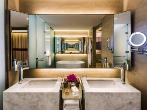 a bathroom with two sinks and a large mirror at Rixos Premium Tekirova - The Land of Legends Access in Tekirova +264 photos