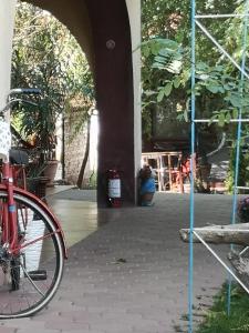a red bike parked in front of a building at Vila VERA in Mahmudia