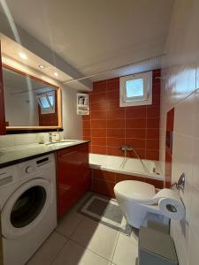 a bathroom with a toilet and a washing machine at JORGO in Kremasti +20 photos