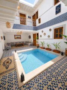 a swimming pool in the middle of a house at Riad Le Sultan Rouge And Spa in Marrakesh