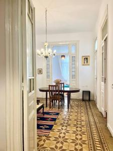 a dining room with a table and a chandelier at Per-en in Cairo