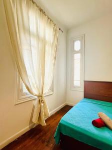 a bedroom with a bed with a curtain and a window at Per-en in Cairo
