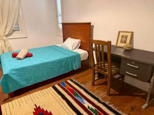 a bedroom with a bed and a desk and a chair at Per-en in Cairo +22 photos