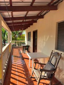 a patio with a table and chairs on a house at Accommodation #7 in Copán Ruinas