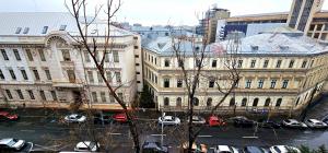 a view of a city with cars parked in a parking lot at Apartament Victoriei - Centru in Bucharest