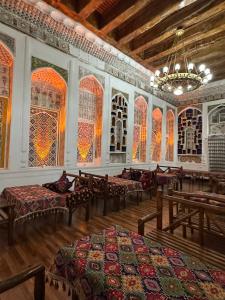 a large room with beds and stained glass windows at Merik Boutique in Bukhara