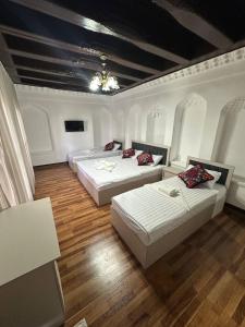 a bedroom with two beds and a ceiling at Merik Boutique in Bukhara