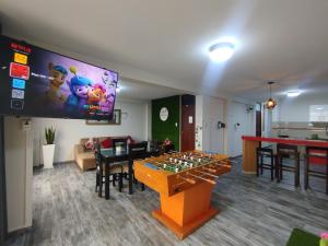 a living room with a table with a game at Apartamentos "APPART D'ELIETTE" in Trujillo