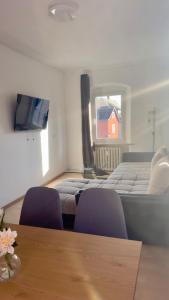 a room with two beds and a table and chairs at Worker's Dream Apartment in Kirchenlamitz