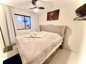 a bedroom with a bed with a towel on it at APT Moderno com Linda Vista in Ponta Grossa