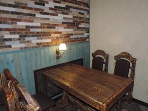 a dining room with a wooden table and chairs at Hotel Uyut in Kovrov in Kovrov